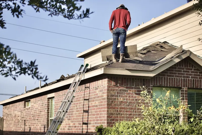 Professional roofer working on a residential roof in Grantville